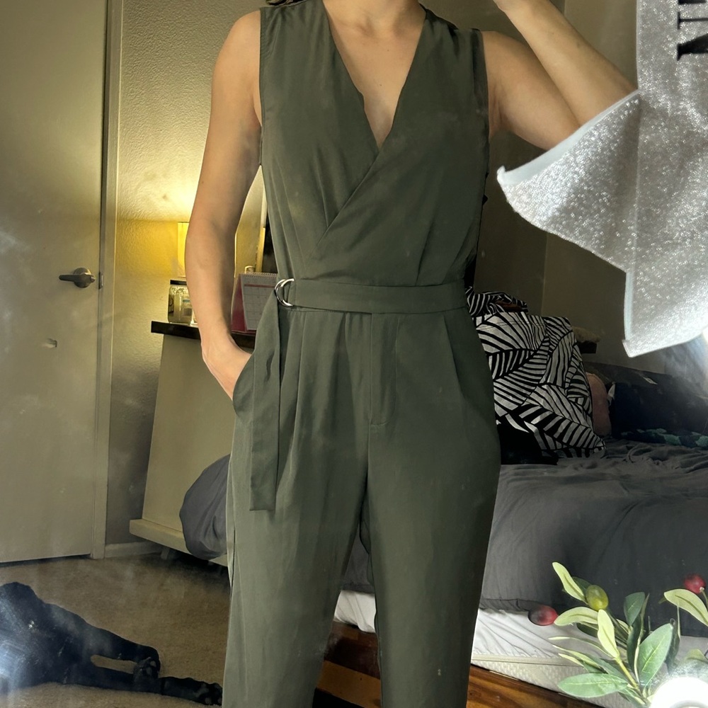 Olive green jumpsuit, zipper and adjustable waist strap.